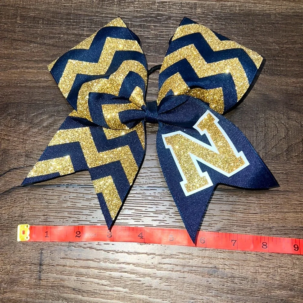 Brand new! Navy & Gold “N” Cheerleading Bow